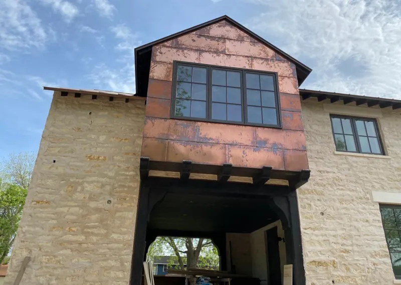 Copper metal panel facade on a stone building for Roof Repair in California